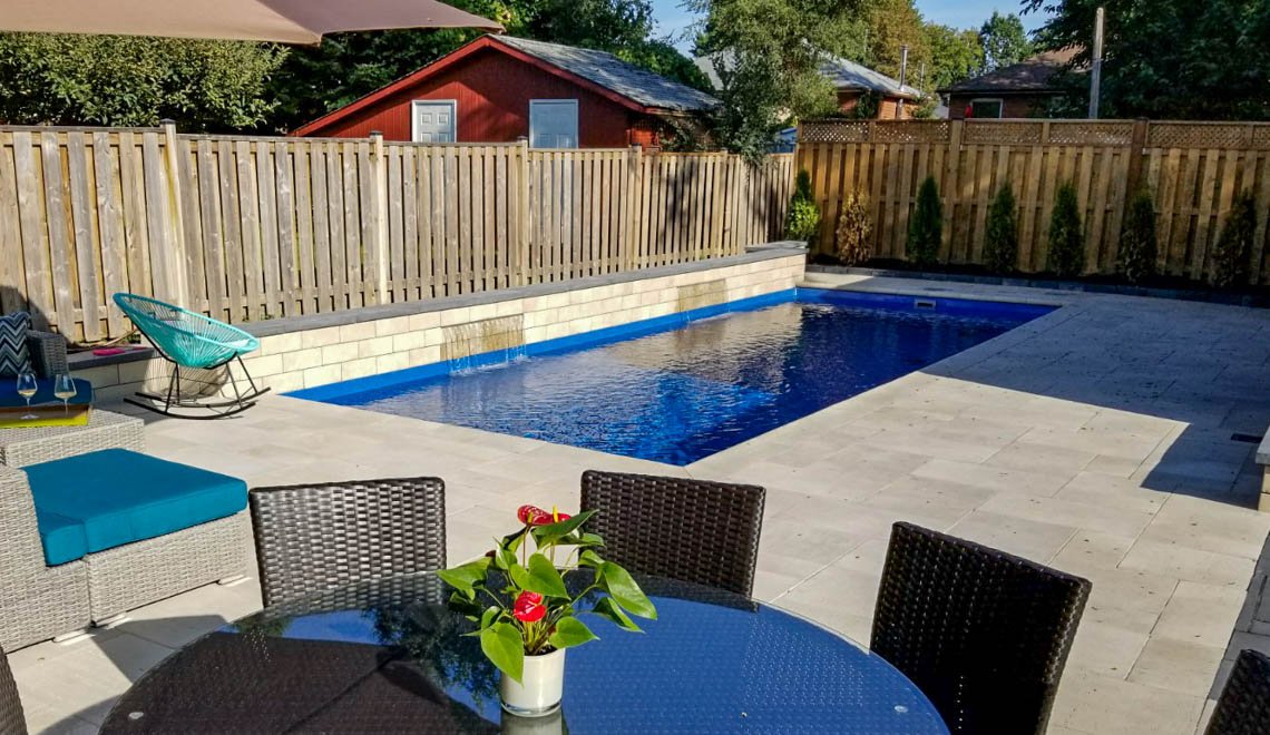 Northern Colorado Pools shows a stylish backyard pool area perfect for relaxing or gathering with friends and family.