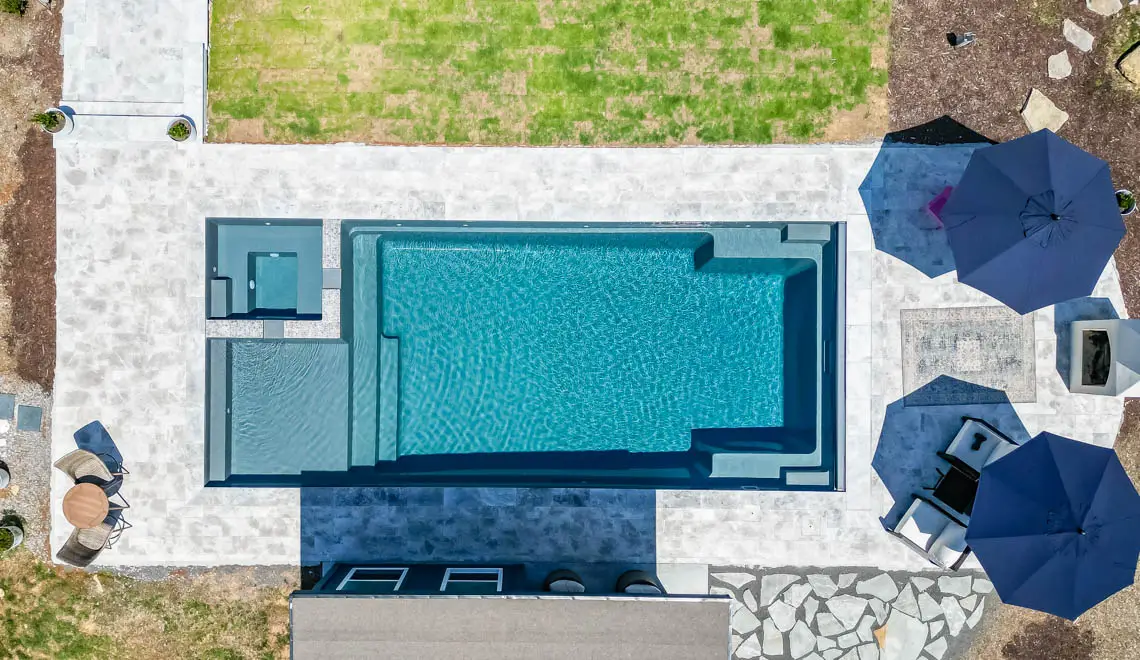 A modern pool and spa designed by Northern Colorado Pools, showing a fun and relaxing outdoor space for families in Mead.