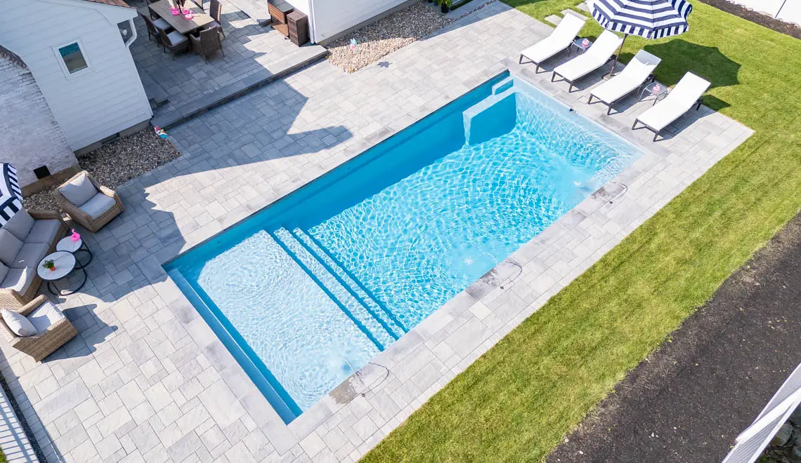 Northern Colorado Pools shows a clean backyard pool, relaxing seating, and a nice outdoor space for family enjoyment.