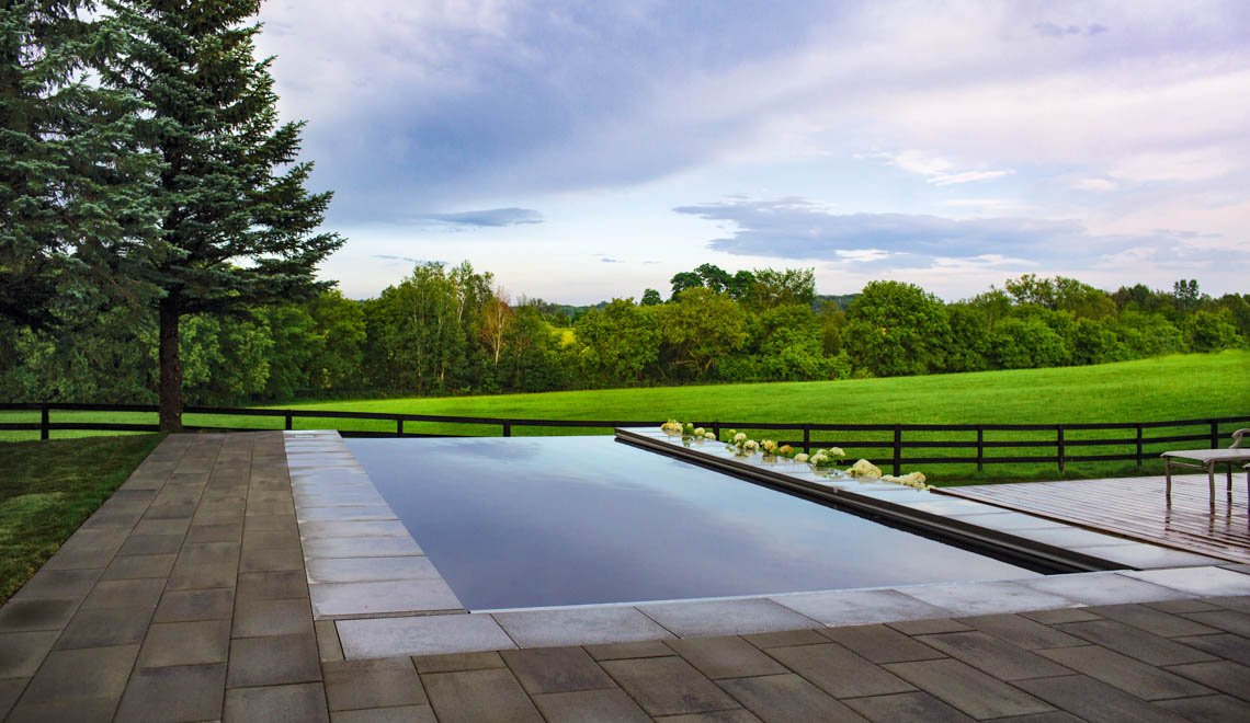 Northern Colorado Pools creates inviting backyard spaces with modern infinity pools for families in Mead, Colorado.