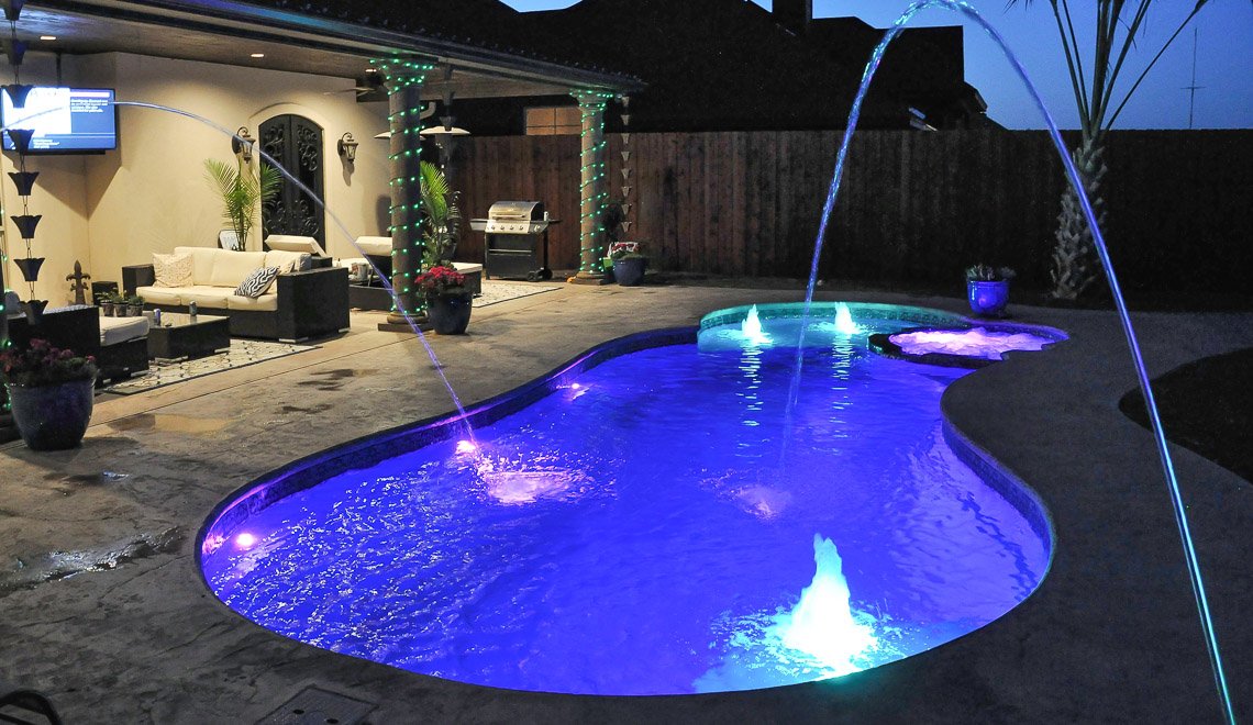Northern Colorado Pools shows a welcoming backyard with a relaxing pool and hot tub, perfect for gatherings at dusk.