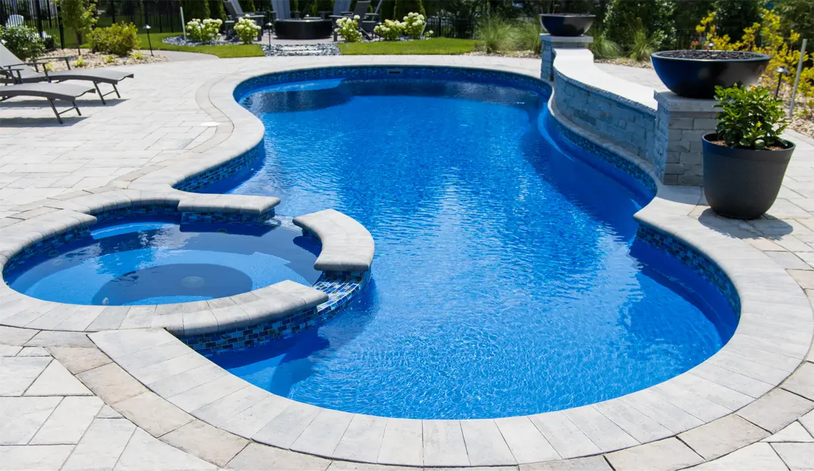 Northern Colorado Pools shows a stylish backyard pool and hot tub setup for comfortable, modern outdoor living.