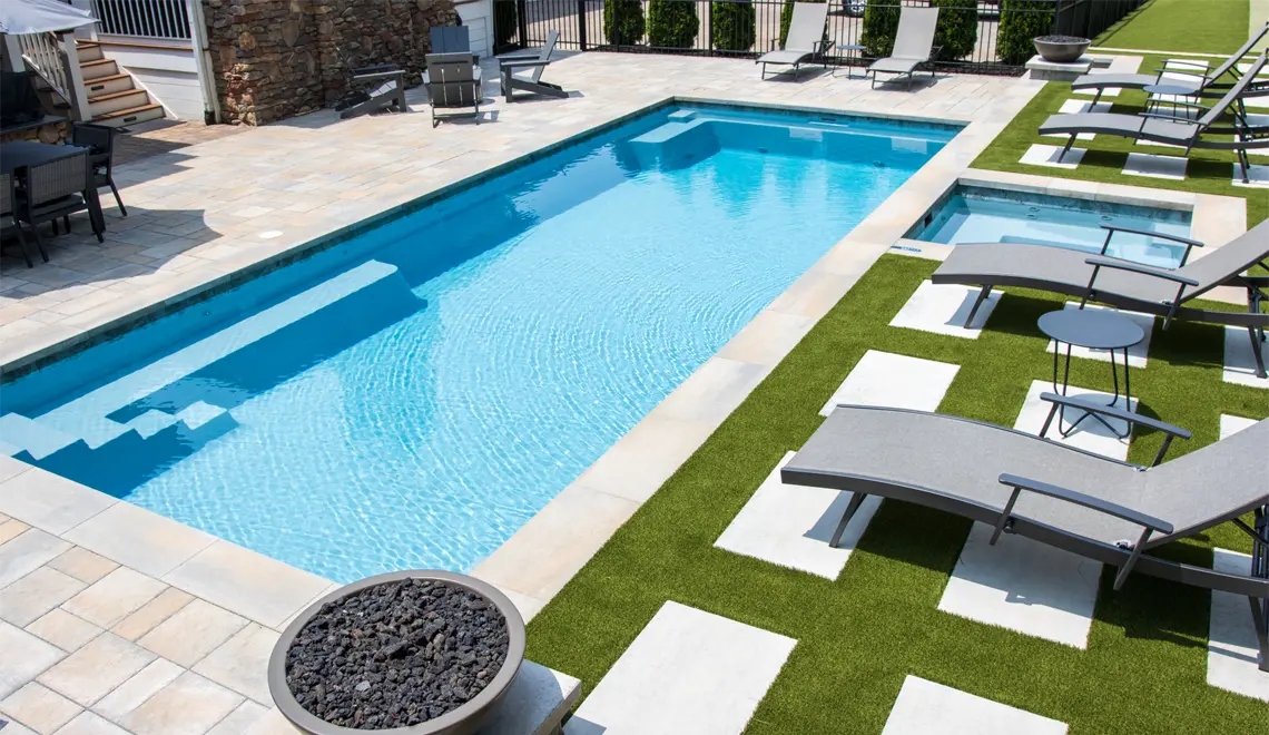 A modern pool by Northern Colorado Pools shows an easy-care spot for relaxing outdoors and enjoying time with friends.